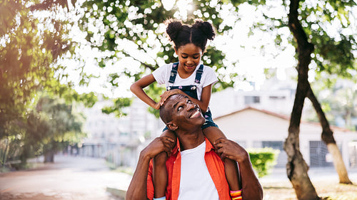 Happy father and daughter smiling and having fun outdoors