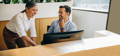 Two business people working together on computer