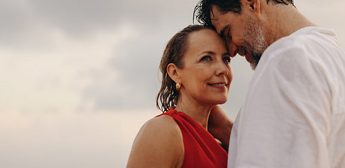 Lasting love between older couple enjoying luxury holiday at the beach
