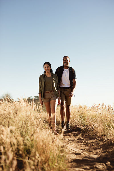 Couple enjoying hiking down a hill