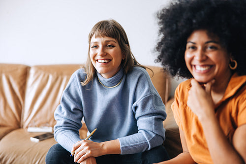 Cheerful young businesswomen sitting in a meeting