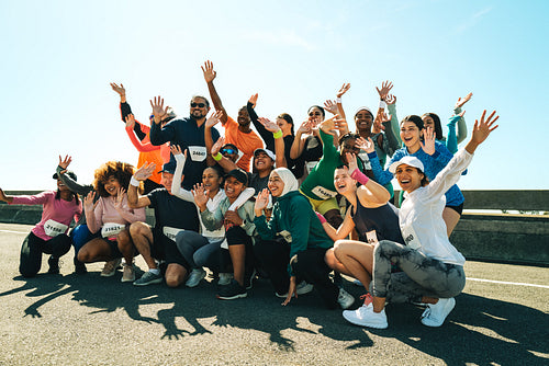 Group photograph of happy runners celebrating marathon finish