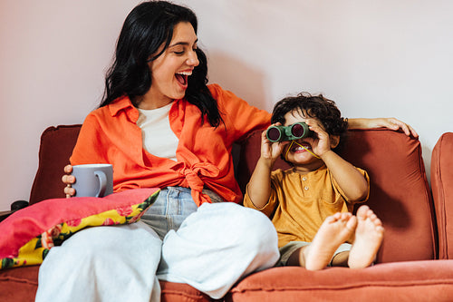 Latina mother and child having fun at home while sharing quality time together