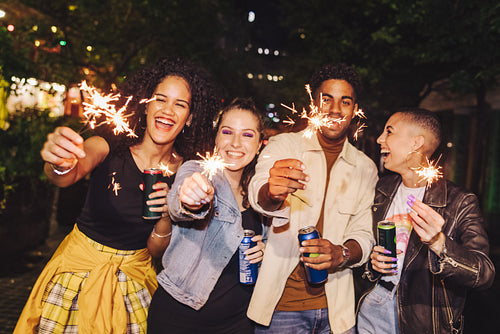 Friends celebrating new year's eve with bengal lights