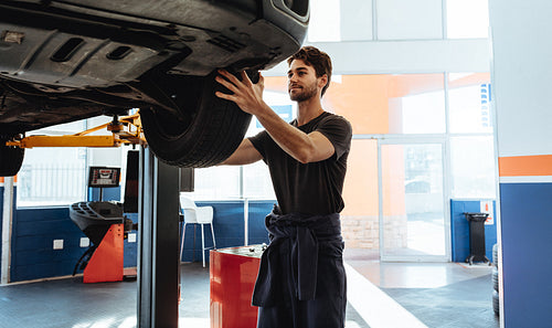 Professional car mechanic working in garage