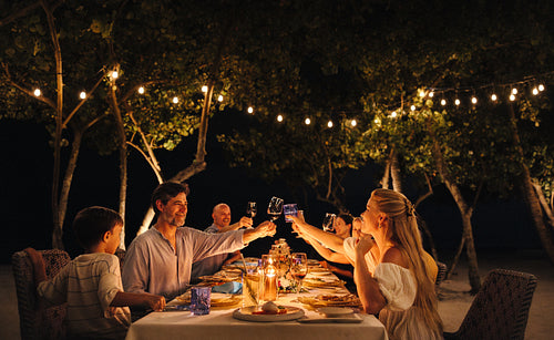 Elegant family dinner at a luxury resort under twinkling lights