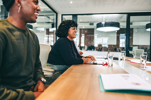 Modern businesspeople smiling in a boardroom