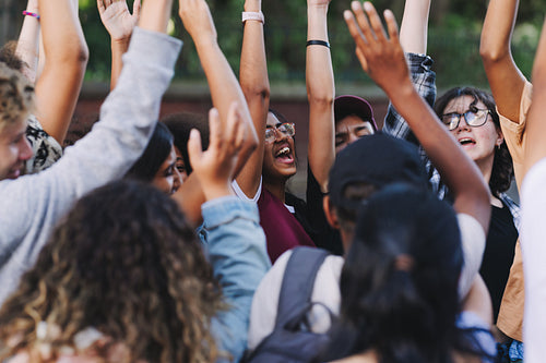 Happy young people cheering at a protest