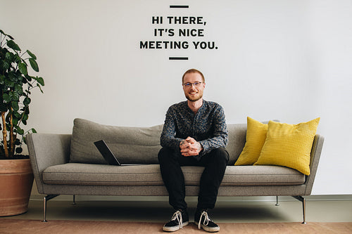 Confident entrepreneur sitting in lobby