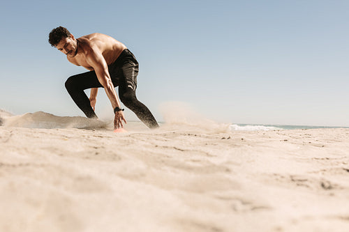 Man doing fitness training at the beach