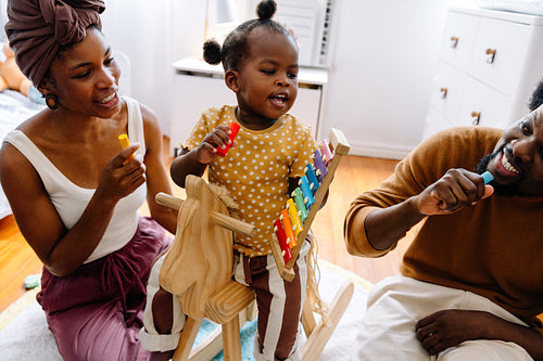 Family playing together with a wooden xylophone