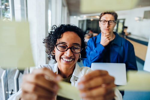 People brainstorm with sticky notes in office
