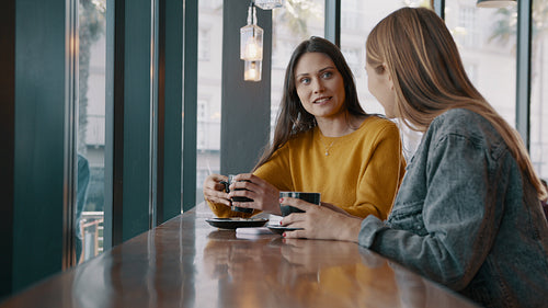 Two best friends meet in a cafe