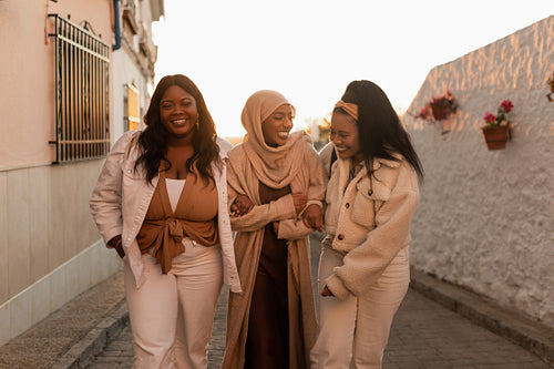 Happy female friends laughing together outdoors