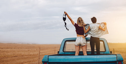 Women having fun traveling by pickup truck