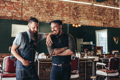 Hairdresser with a man standing at barbershop