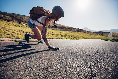 Young woman riding on her skateboard