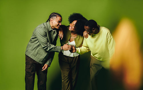 Friends dancing together in studio with playful energy and smiling young people
