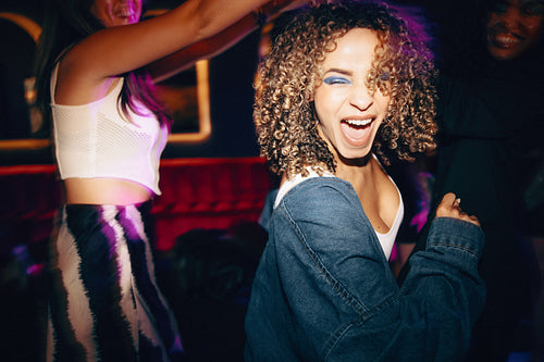Young women enjoying a fun night out at a lively club