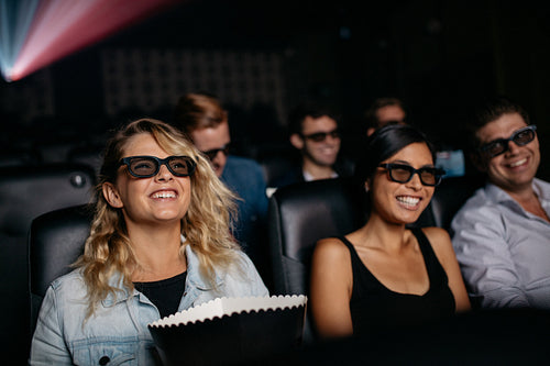 Group of friends watching 3d movie in cinema