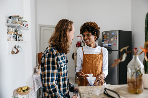 Young couple enjoys a cozy coffee break in modern kitchen