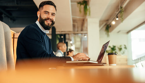 Businessman working on his laptop in a co-working space