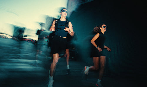 The running woman leads group fitness on an urban street