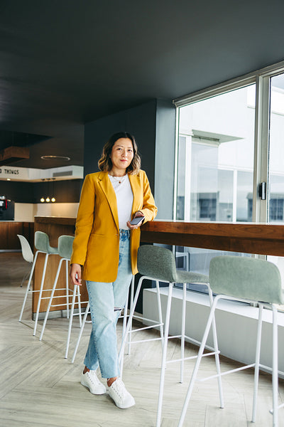 Cheerful businesswoman standing in a co-working office