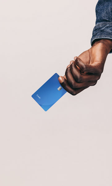Black man going shopping with a credit card, he holds out his bank card in his hand