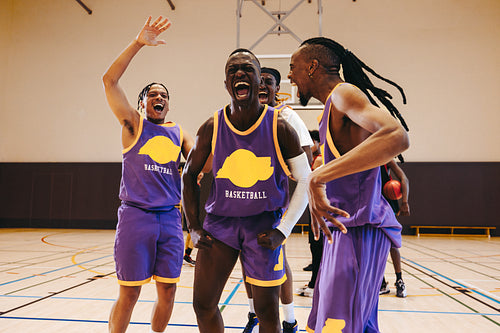 Excited basketball players celebrating together