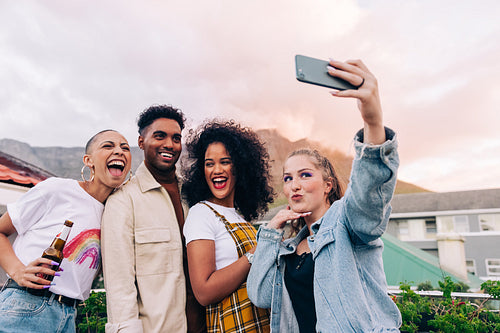 Friends taking a group selfie outdoors