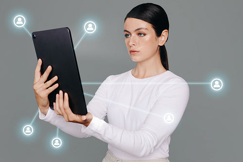 Woman connecting with other tech users with a smart digital tablet