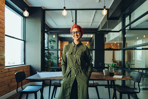 Happy female entrepreneur smiling cheerfully in an office