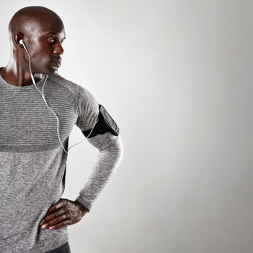African male model with earphone looking at copy space