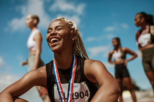 Sportswoman with medal celebrating her victory