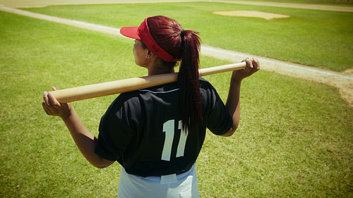 Batter surveys the diamond with her bat