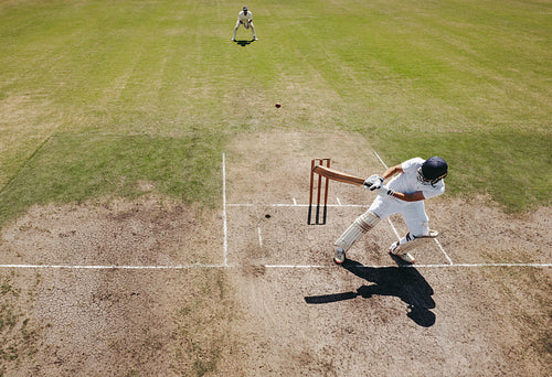 Cricket batsman playing a reverse shot during a match