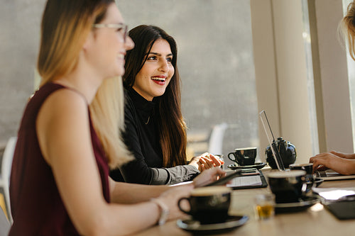Multi-ethnic businesswomen having break during meeting