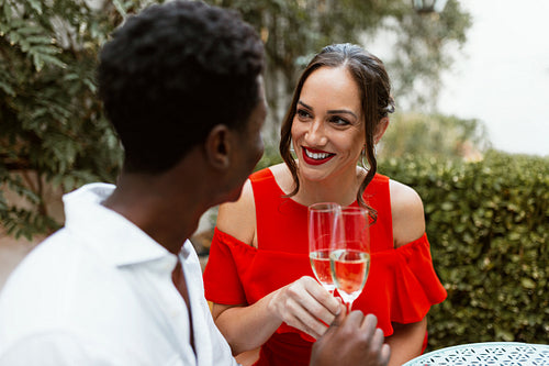 Cheerful young couple making a toast on their anniversary