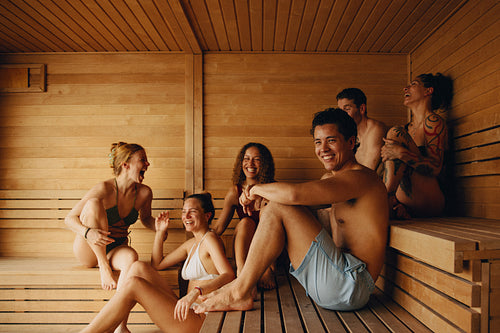Friends enjoy nordic wellness and laughter in a social sauna setting