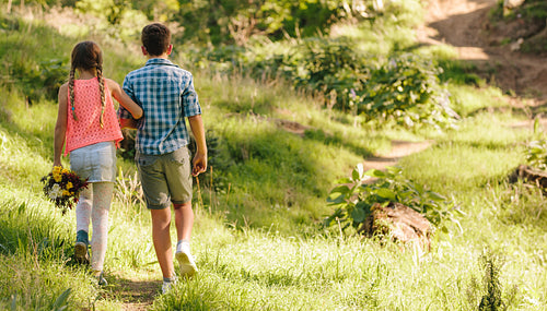 Kids in love walking in a park together