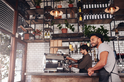 Coffee shop owner standing at the counter