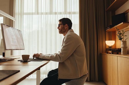 Man working on computer in Scandinavian office