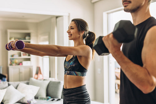 Couple doing weights workout at home