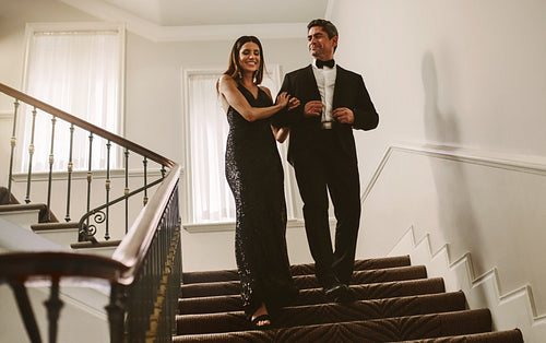 Beautiful couple walking down the stairs