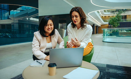 Actuarial scientists discussing strategies during a video call in a sleek business environment