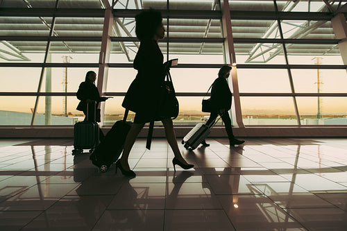 Silhouette of people walking at airport terminal