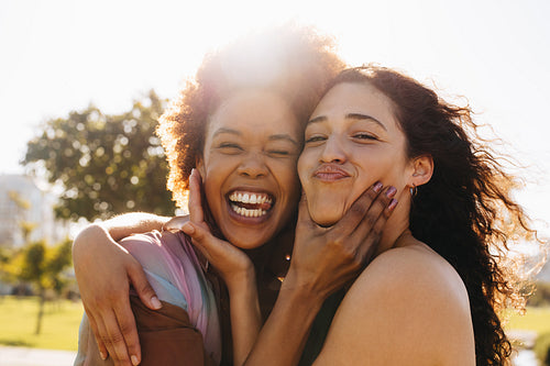 Best friends embracing and enjoying the summer sun