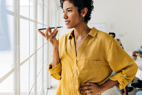 Black business woman talking on a phone call in an office