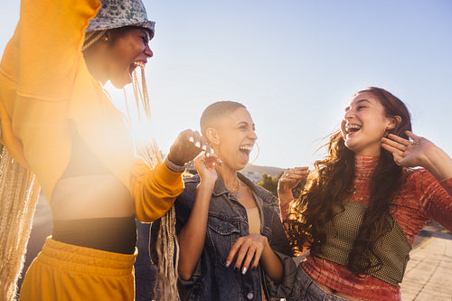 Girlfriends laughing together in the summer sun